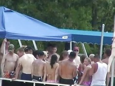Outdoors water party with many wild teens
